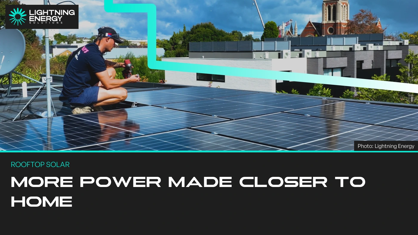 Lightning Energy solar installer working beside rooftop panels.
