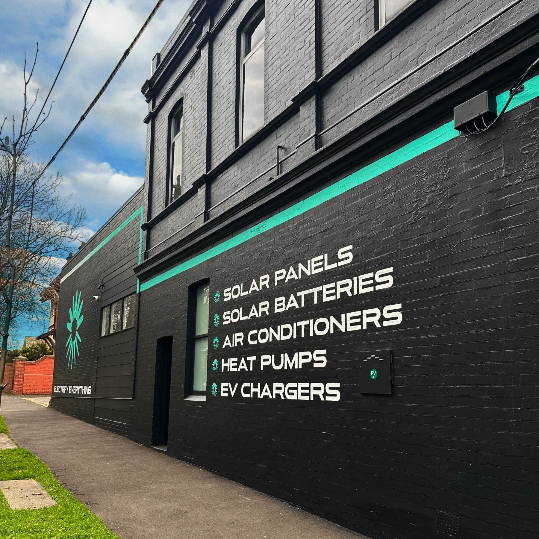 Lightning Energy showroom signage listing solar, batteries, air conditioning, heat pumps, and EV chargers