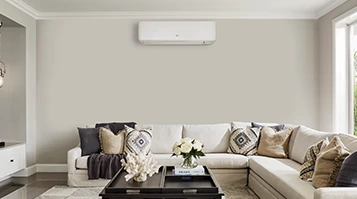 GENERAL residential wall-mounted air conditioner in a manufacturer room photograph. The pictured model is not identified; specifications depend on the quoted series.