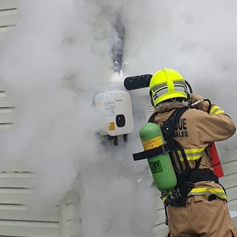 Picture of a fighfighter putting out an inverter fire