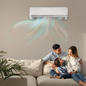Family sitting comfortably under a single split air conditioner in Melbourne. Front on view, man and women sitting together on couch with child laying across them, artistic blue lines flow from air con unit to illustrate air flow