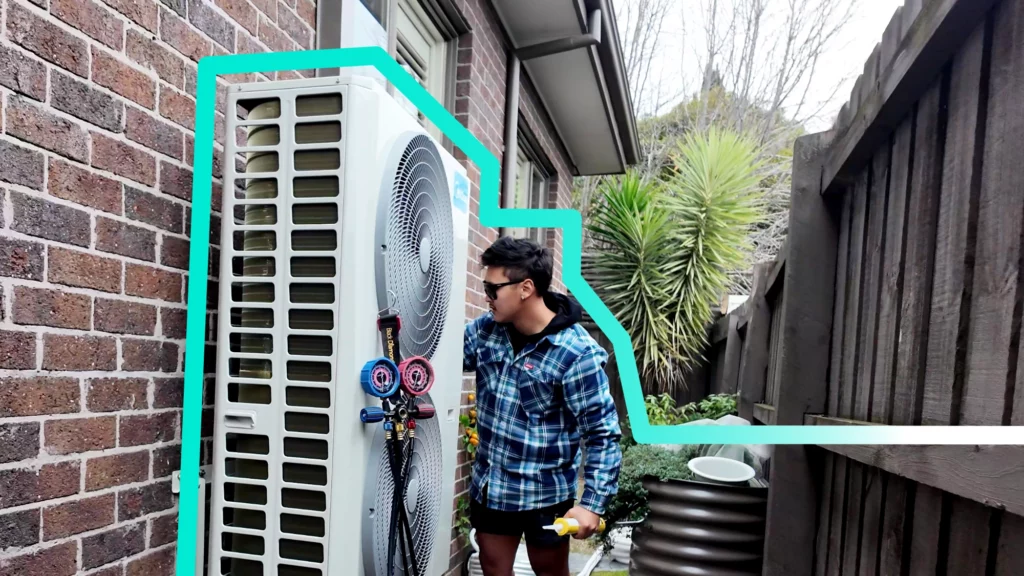 Technician installing an air conditioner in Melbourne. Professional AC installation with in-house tradesmen, ensuring quality heating and cooling solutions. Victorian Energy Upgrades rebates available for energy-efficient air conditioning systems