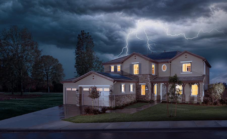 Melbourne home with lights on during storm, showcasing energy independence and solar battery backup with SolarEdge system in unpredictable weather